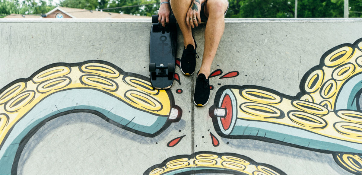 Symbolbild: Mann sitzt auf einer Mauer